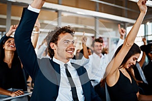 Looks like they have some questions. Cropped shot of a group of young businesspeople sitting with their hands raised