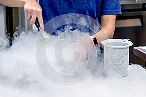 Worker making ice cream with liquid nitrogen photo