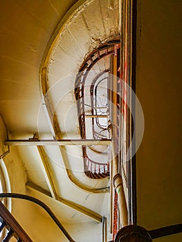 Lookup to spiral staircase in old tenement house