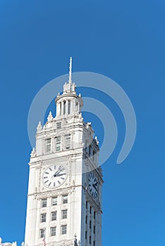 Lookup view of typical skyline building with rooftop tower clock in Chicago downtown