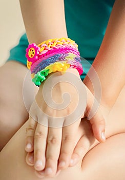 Loom bracelets on child hand.Rubber colorful wrist accessories.