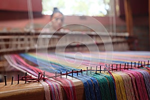 Loom and Weaver with Bright Threads near San Ramon, NIcaragua