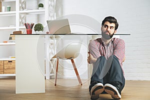 Loony businessman on office floor photo