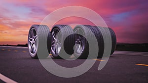 Loop car tires rolling on asphalt in the sunset