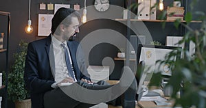 Loop of Middle Eastern businessman typing with computer looking at monitor working in office concentrated on job