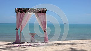 Loopable Cinemagraph of Pink Wedding Arch on Sandy Beach Beside the Sea