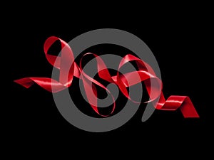 Looping red silk or satin ribbon on black