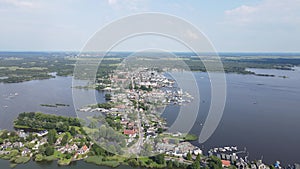 Loosdrecht Loosdrechtse Plassen aerial drone view on a summer day houses and road dyck road running through the water.