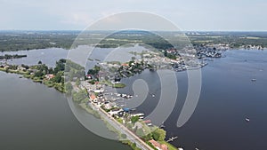 Loosdrecht Loosdrechtse Plassen aerial drone view on a summer day houses and road dyck road running through the water.