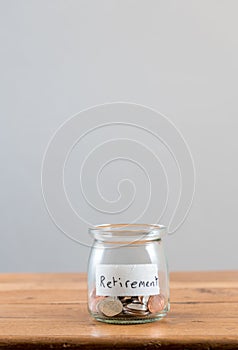 Loose change inside glass jar to represent retirement savings