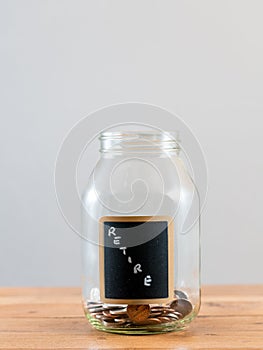 Loose change inside glass jar to represent retirement savings