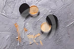 Loose compact mineral powder for face on stone background. Eco friendly and organic cosmetics.