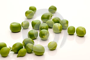 Loose garden peas on white