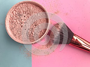 Loose powder in a beige shade on a pink-blue stylish background. masking acne, pores, skin imperfections. quick makeup. face make-