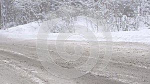 Loose Snow Flies from under Truck Wheels on the Highway