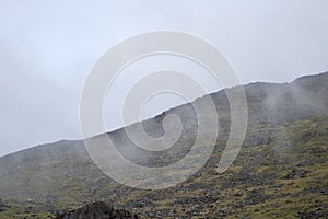 Loose stones, rocks and boulders on a misty mountain top