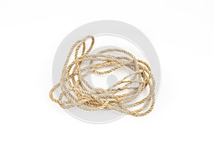 Loose tangled jute rope coil, isolated on white