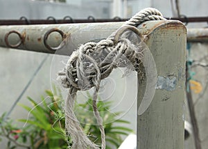 Loose rope on steel fence