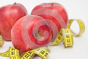 Loose Weigh. Three Red Apple with Measure Tape for , in the Middle of Image, diet and fitness with copy space .