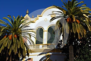 Lope de Vega theatre and palm trees, Seville, Spain.