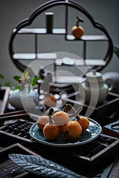 Loquat fruit on the table in architectural interior with oriental charm(Eriobotrya japonica), dark environment