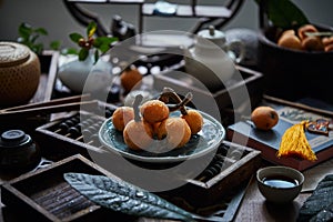 Loquat fruit on the table in architectural interior with oriental charm(Eriobotrya japonica), dark environment