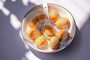 Loquats on the plate under the sun