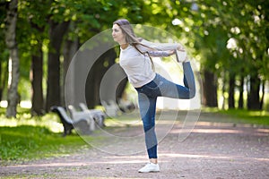 Lord of the Dance pose in park alley