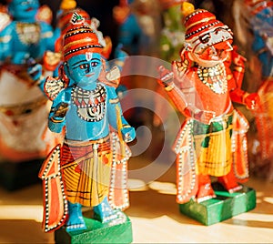 Lord Krishna and Narasimha wooden toys in retro traditional style, in showcase of indian store