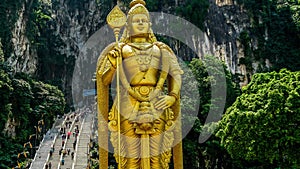 Lord Murugan Hindu Deity Statue at Batu Caves and tourist flow in Malaysia Time Lapse 4K