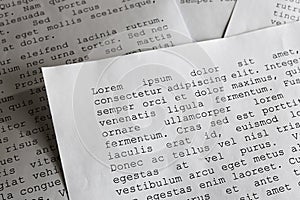 Lorem ipsum dolor sit amet concept. selective focus photo of paper sheets with publishing and graphic design placeholder text on photo