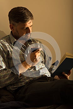 Lorn man relaxing with book