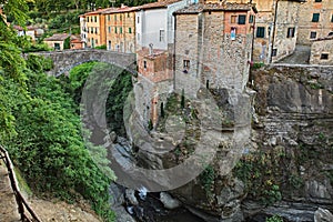 Loro Ciuffenna, Arezzo, Tuscany, Italy: view of the stream that crosses the ancient village with the medieval humpback bridge photo