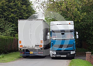 Lorries meeting on a narrow road.