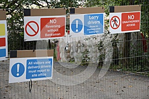 Lorry driver take care and caution sign at construction building site entrance