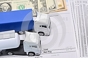 A lorry toys, payroll with dollar bill and face mask