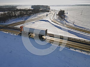 Lorry truck on the road surrounded by winter fields