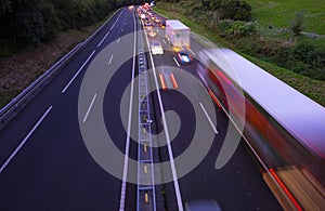 Lorry trucks and cars in traffic jam on the highway at sunset photo