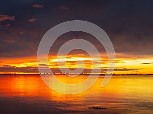 Los Alcazares, Region of Murcia, Spain. Amazing sunrise at seaside with sun reflection on water photo