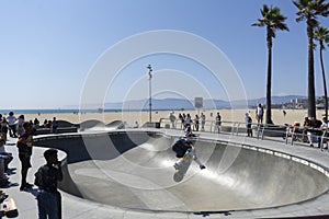 Los Angeles, CA - August 9 2021: Skate board park at Venice beach with young boy practicing outdoors