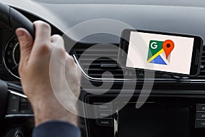 LOS ANGELES, CALIFORNIA - JUNE 6, 2019: Close up to male driving and using navigation appliction Google Maps. Get direction. An