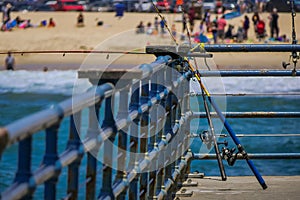 Los Angeles, California, USA, JUNE, 15, 2018: Outdoor view of fishing rods standing in a wooden pier used for people