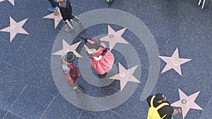 LOS ANGELES, CALIFORNIA, USA - 7 NOV 2019: Walk of fame promenade on Hollywood boulevard in LA. Pedastrians walking near celebrity