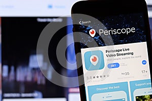 Los Angeles, California, USA - 27 November 2019: Periscope app icon on mobile phone screen with blurry website on laptop,