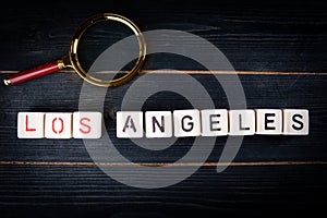LOS ANGELES. City name from alphabet blocks on dark wood texture background