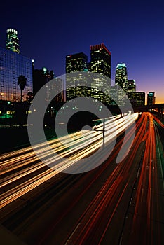 Los Angeles skyline with streaked freeway lights