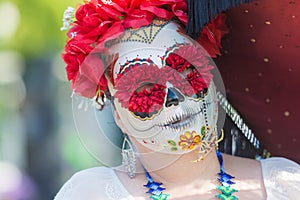 Woman with sugar skull makeup during Day of the Dead