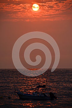 Los Muertos beach against sunset sky