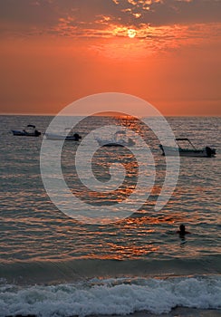 Los Muertos beach against sunset sky.