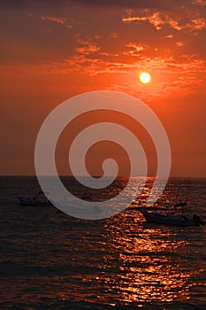 Los Muertos beach against sunset sky.